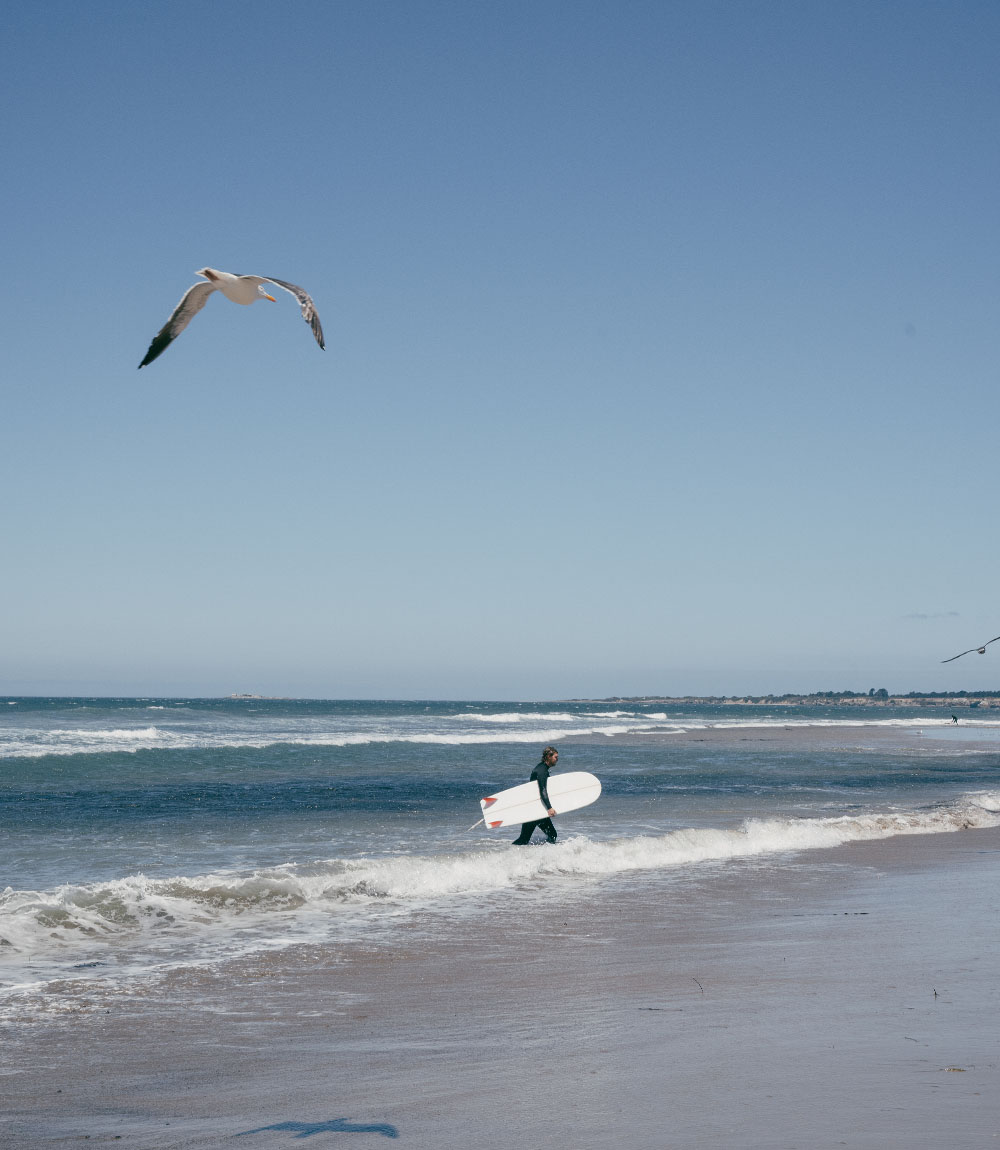 Man with a surfboard in the Pacific ocean