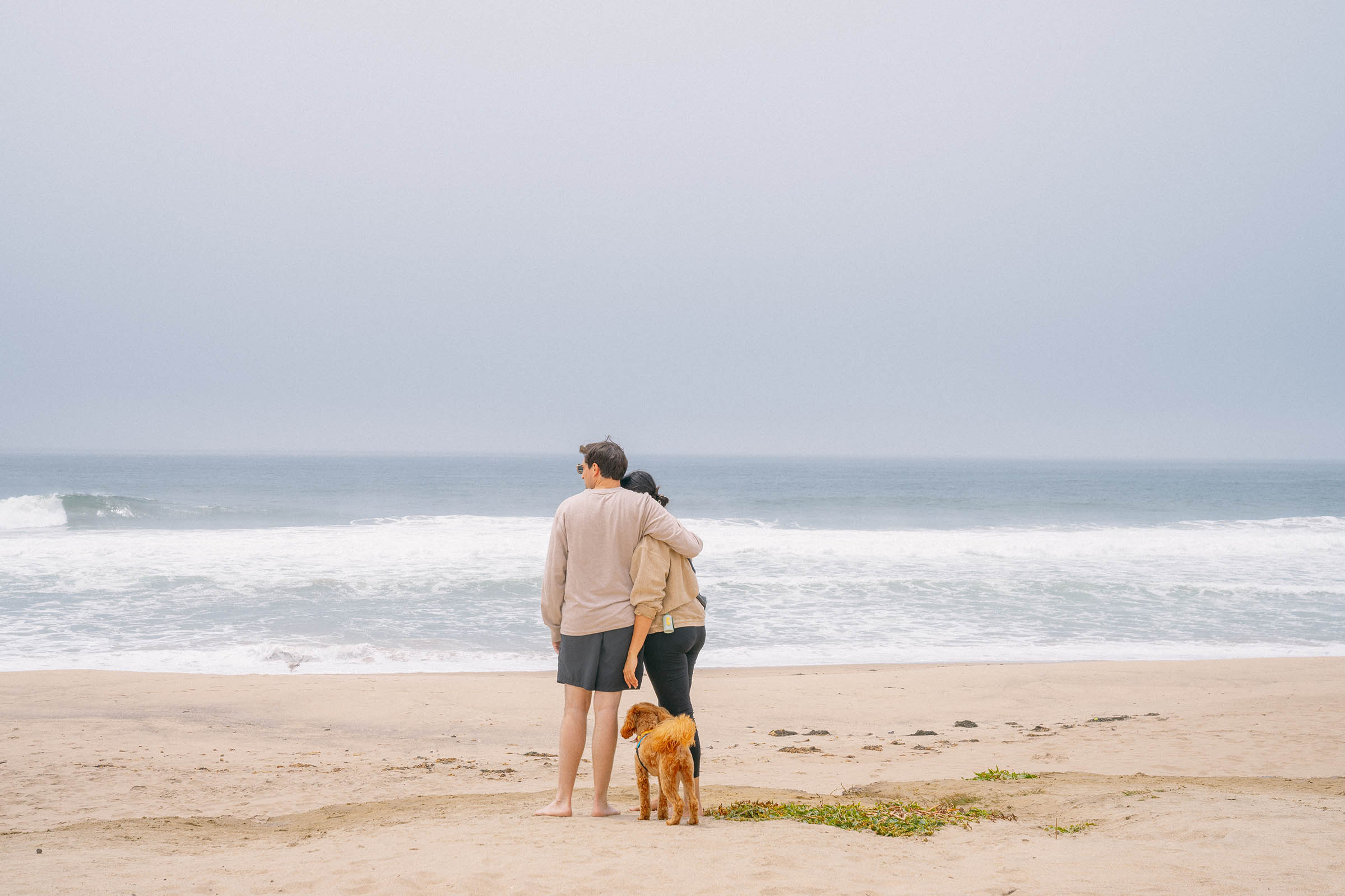 Couple and a dog at the beach in California